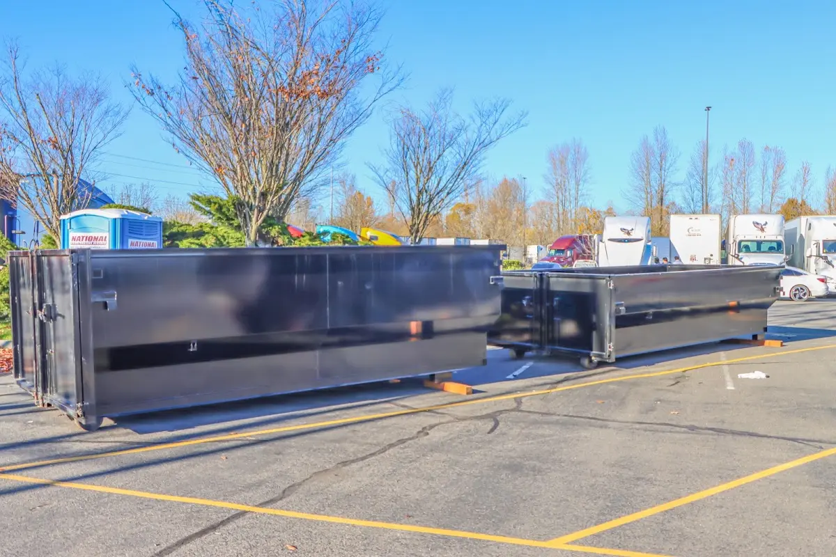 Professional dumpster rental service with roll-off container on residential driveway in Brook Highland